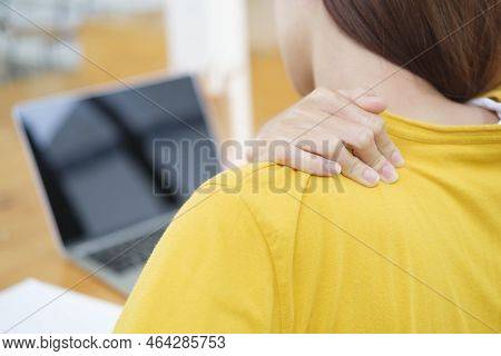 Young Woman Working Or Studying Using Laptop At Workplace Has A Problem With Back Pain. Woman Having