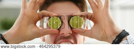 Portrait Of Guy Put Lime Fruit Slices On Eyes Instead Of Glasses, Goofing Around, Funny Man. Choose 