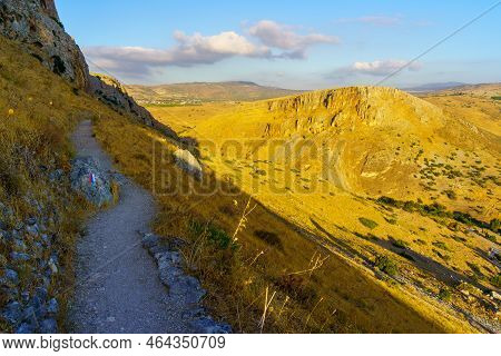 View Of Rocks, Cliffs, Footpath With Israel National Trail Mark, And Mount Nitai, In Mount Arbel Nat