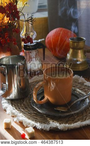 A Cup Of Coffee With Cezve And A Pumpkin On Wooden Table, Cozy Autumn Morning Concept.