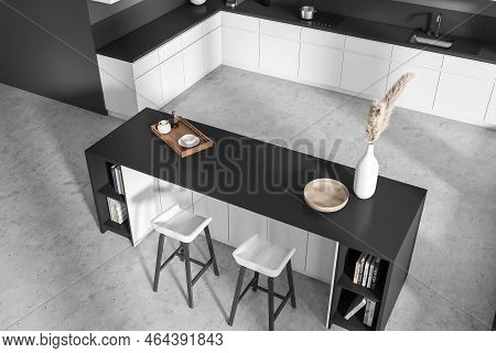 Top View On Dark Kitchen Room Interior With Island, Barstools, Grey Wall, Concrete Floor, Sink, Gas 