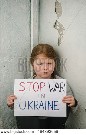 Upset Poor Toddler Girl Kid Protesting War Conflict Raises Banner With Inscription Text Stop War In 