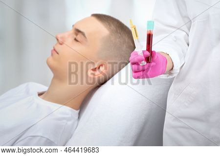 Cosmetologist Does Prp Therapy Of A Handsome Guy In Beauty Salon. The Cosmetologist Holds A Test Tub