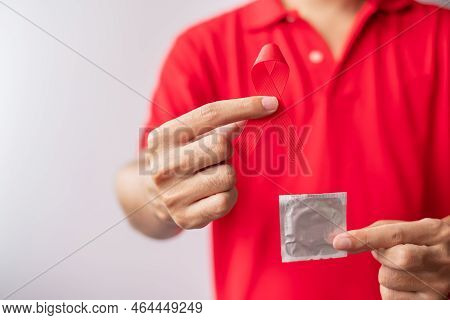 December World Aids Day With Red Ribbon And Condom, Acquired Immune Deficiency Syndrome, Prevention,