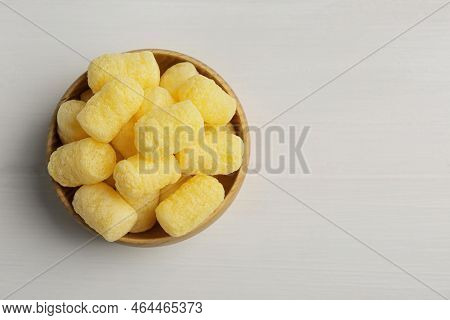 Bowl Of Delicious Crispy Corn Sticks On White Wooden Table, Top View. Space For Text