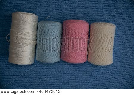 Macrome Threads Of White,blue,pink,beige On A Blue Surface