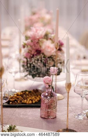 Beautiful Pink Flowers In Bouquets On The Batle In Restaurant. Elegant Decoration For The Celebratio