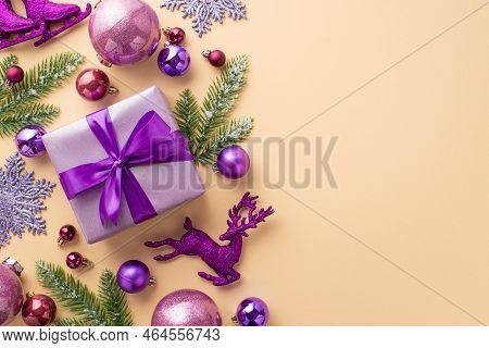 Christmas Concept. Top View Photo Of Violet Giftbox With Ribbon Bow Pink Purple Baubles Deer Snowfla