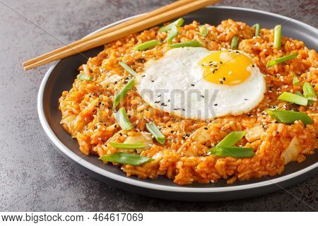 Homemade Kimchi Fried Rice Topped With Fried Egg Closeup On The Plate On The Table. Horizontal