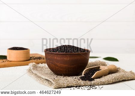 Quinoa Seeds In Bowl And Spoon On Colored Background. Healthy Kinwa In Small Bowl. Healthy Superfood