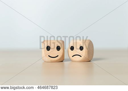 Face Emotion Positive And Negative Concept. Wooden Cube With Smiley Face And Sad Face Icon. Satisfac