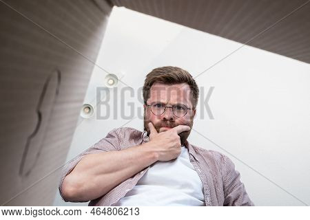 Thoughtful Man Unpacked The Delivered Box With A Parcel, He Is At A Loss, He Was Not Brought What He