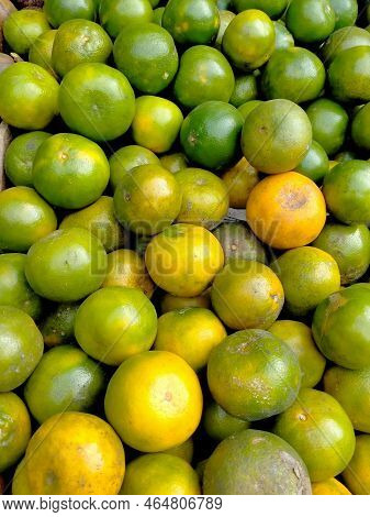 Oranges And Mangoes On Sale In A Fruit Market Stall.