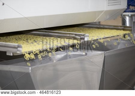 Pasta Factory And Stages Of Pasta Production. The Operation Of Drying Pasta On An Industrial Machine
