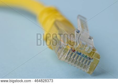 A Closeup Of Yellow Patch Cord In Blue Background
