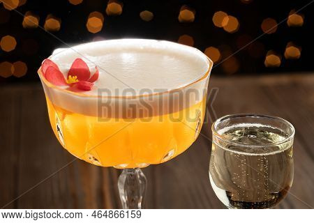Cocktail On A Wood Background. Cold Citrus Alcoholic Drink With Aperol, Passion Fruit Syrup And Pros