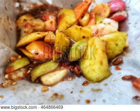 Close Up Photo Of Fruit Salad Covered With Rujak Seasoning With Palm Sugar And Chili.