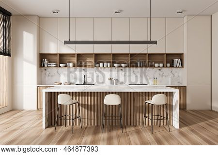 Front View On Bright Kitchen Room Interior With Island With Barstools, White Wall, Oak Wooden Hardwo