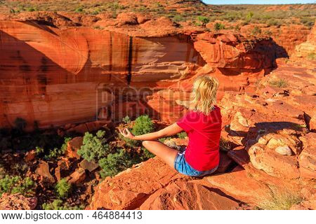 Peaceful Woman Doing Yoga Meditation In Lotus Pose At Edge Of Kings Canyon In Watarrka National Park