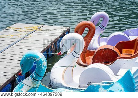Swan Shaped Boats Tied On Lake Edge In Kashmir Bhimtal Naukuchiatal On The Blue Waters With Forests 