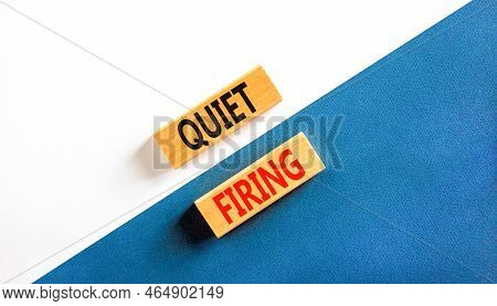 Quiet Firing Symbol. Concept Words Quiet Firing On Wooden Blocks. Beautiful White And Blue Backgroun