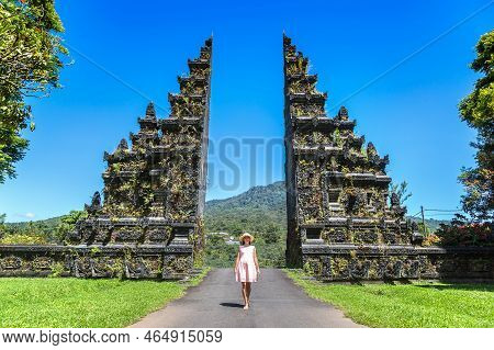 Woman Traveler At  Bali Handara Gate In Bali, Indonesia In A Sunny Day