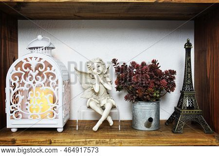 White Lantern With Ceramic Coll And Artificial Plamt On Wooden Shelf Home Decortion