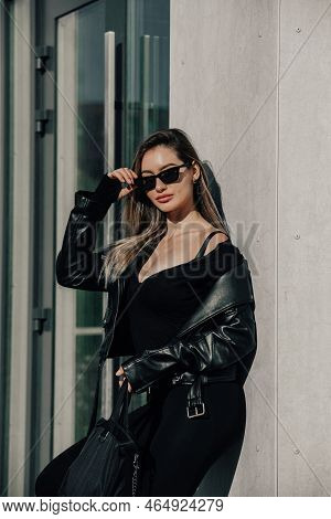 Fashionable Young Woman With Long Hair Wearing Solid Long Sleeve Bodycon One Piece Jumpsuits Posing 