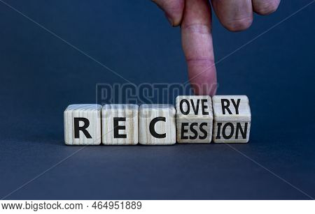 Recovery And Recession Symbol. Businessman Turns Cubes And Changes The Word 'recession' To 'recovery