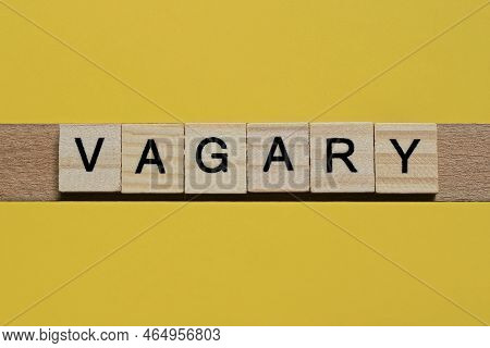 The Gray Word Vagary Of Gray Small Wooden Letters Lies On A Yellow Table