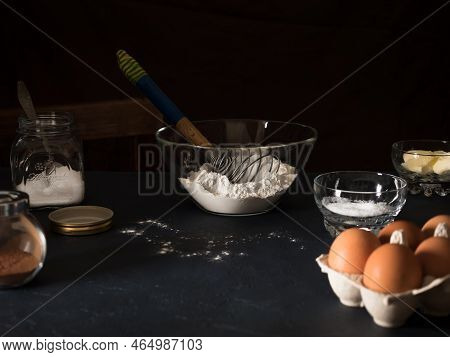 Cooking A Cake. On The Table Are Ingredients For Making A Pie Flour, Butter, Sugar, Salt, Cocoa, Egg