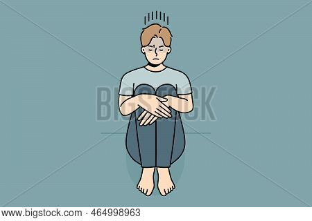 Unhappy Young Man Sitting On Floor Suffer From Loneliness Or Depression. Upset Sad Guy Struggle From