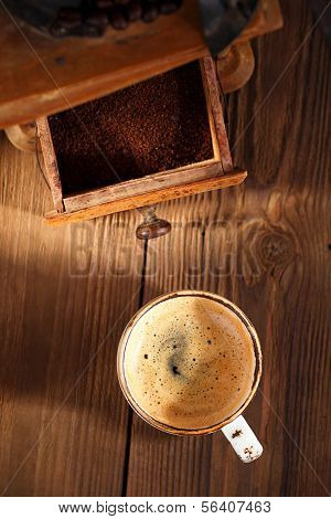 A cup of espresso coffee with Old coffee mill  textured tablem rustic style