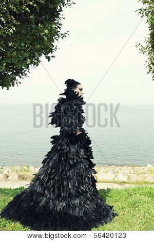 Fashion woman posing near the sea. Dark Queen.