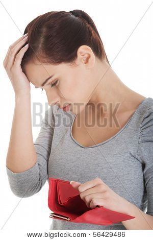 Beautiful casual woman showing her empty wallet. Isolated on white.