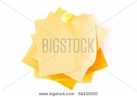 Yellow small memo attached with drawin pin. Isolated on white.
