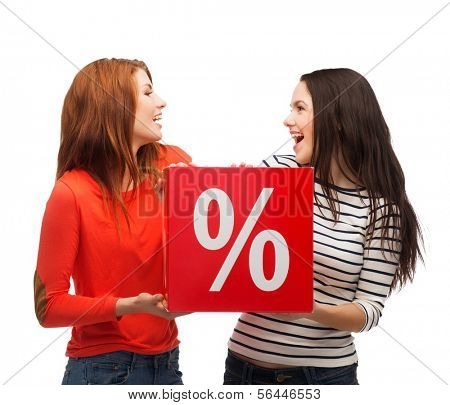 shopping, sale, and gift sconcept - two smiling teenage girls with percent sign on red box
