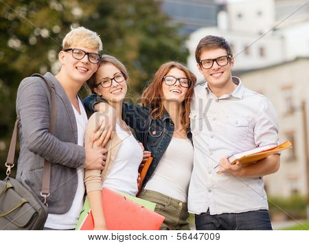 summer holidays, education, campus and teenage concept - group of students or teenagers with files, folders and eyeglasses hanging out