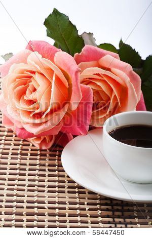 Cup of Coffee and Beautiful Bouquet of Fresh Flowers on Table