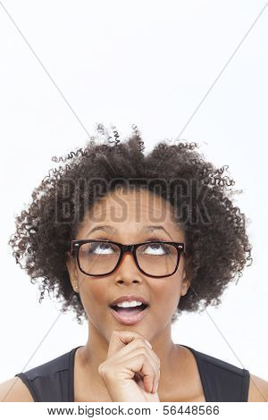 A beautiful intelligent mixed race African American girl or young woman looking up happy thoughtful surprised and wearing geek glasses