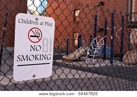 Children At Play - No Smoking As Warning Message, Sign On Metal Grid