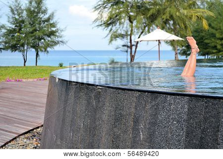 Girl in empty infinity pool