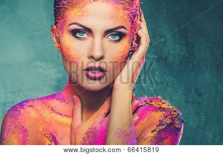 Beautiful young woman with conceptual colourful body art 