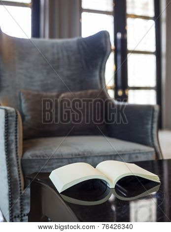 Armchair In Living Room Pillow and Book On Table