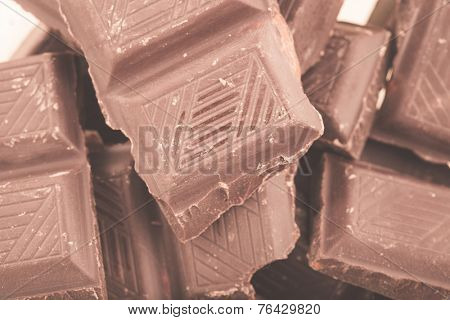 Pieces of milk chocolate closeup. Macro photo