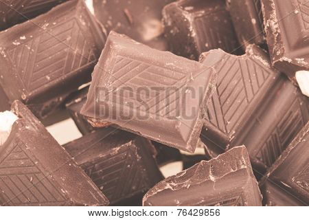 Pieces of milk chocolate closeup. Macro photo