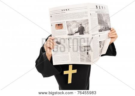 Sneaky priest peeking through a hole in newspaper isolated on white background