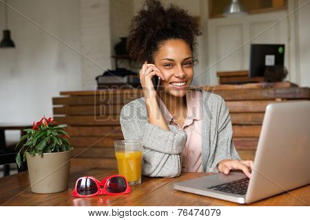 Happy Young Woman Talking On Phone At Home