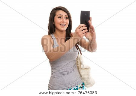 Young female tourist sending greetings in video conversation