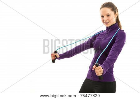 Cheerful young woman with jump rope over neck